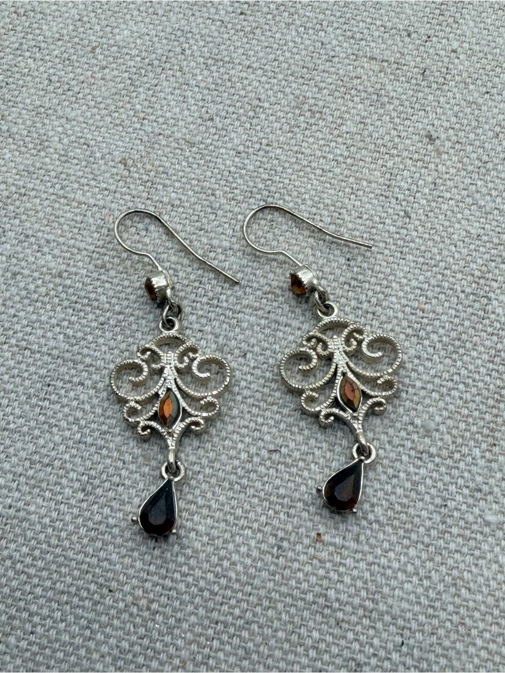 Ornate Silver Drop Earrings with Garnet-Colored Stones